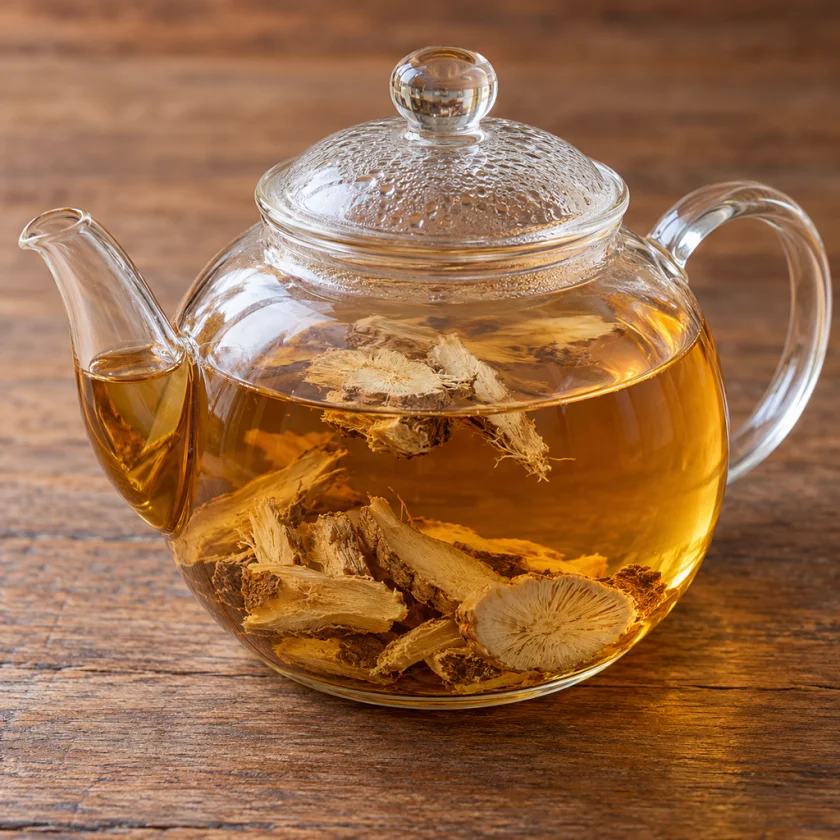 Dried slices of elecampane root steeping in a glass teapot